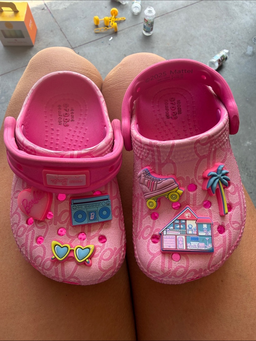 CROCS Kids' Pink Slip-On Clogs with Playful Charm Accents